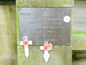 Peace poppies on the memorial plaque